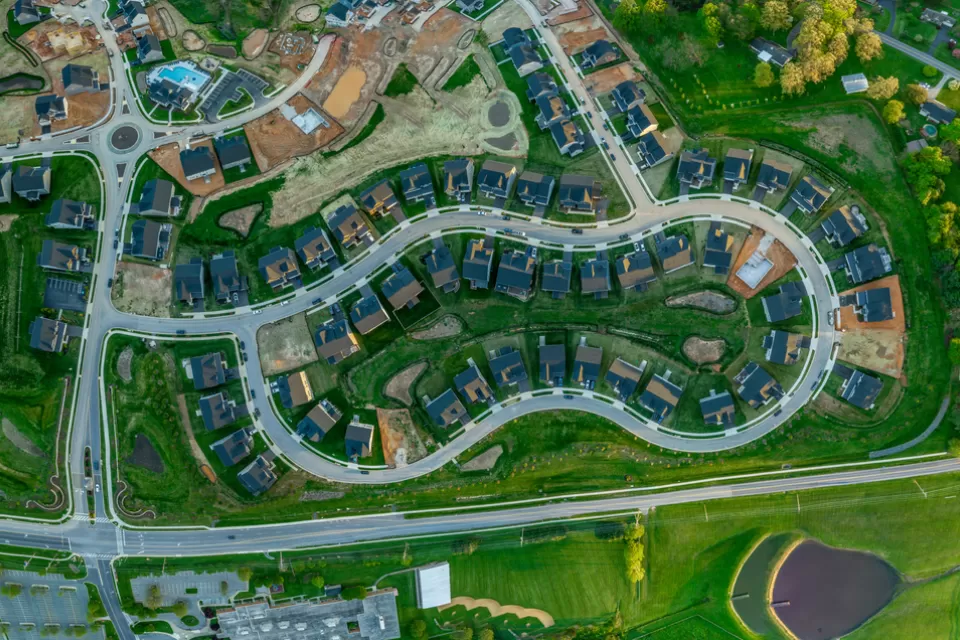Aerial overhead view of single-family neighborhood with some houses under construction